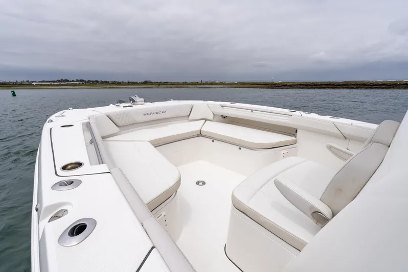  Yacht Photos Pics 2024 World Cat 325 CC boat with spacious seating on calm water.