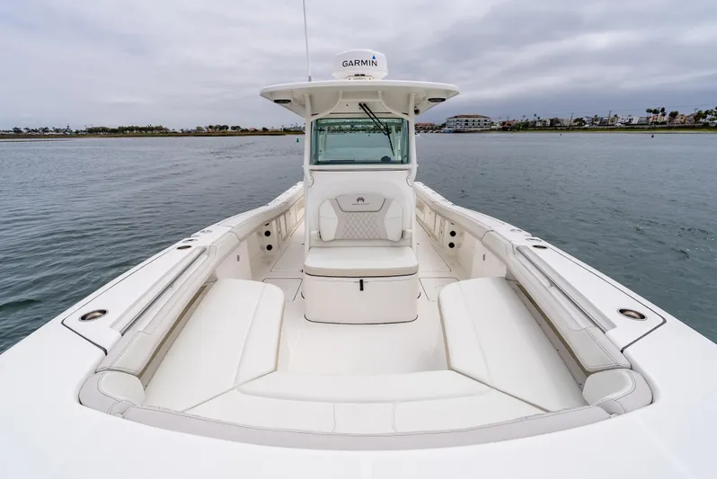  Yacht Photos Pics 2024 World Cat 325 CC boat with spacious seating on calm water.