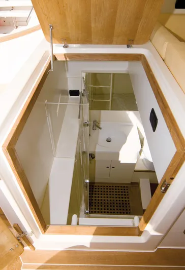 51 Yacht Photos Pics Modern Toy 51 yacht interior with wooden accents, featuring a compact bathroom.