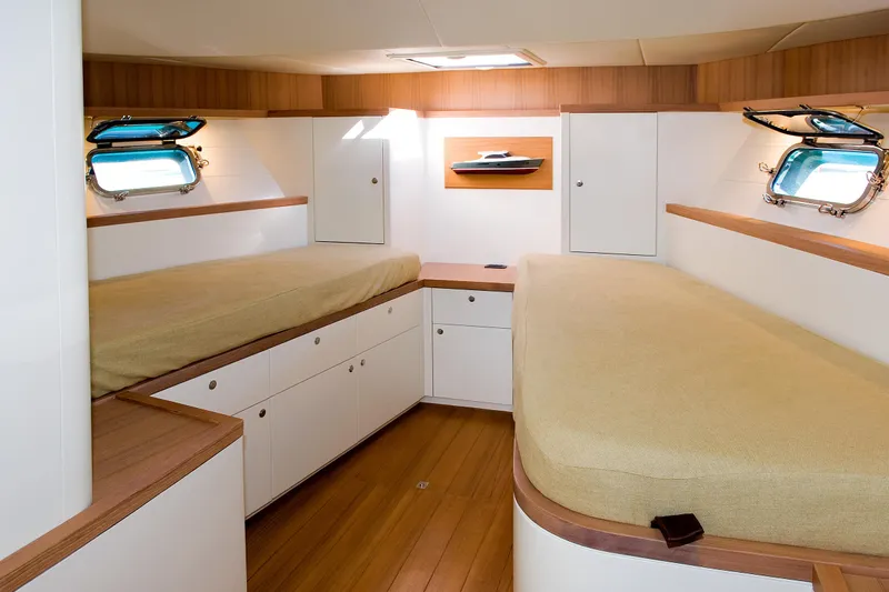 51 Yacht Photos Pics Luxurious Toy 51 yacht cabin interior, 2025 model, featuring twin beds and elegant wood finishes.