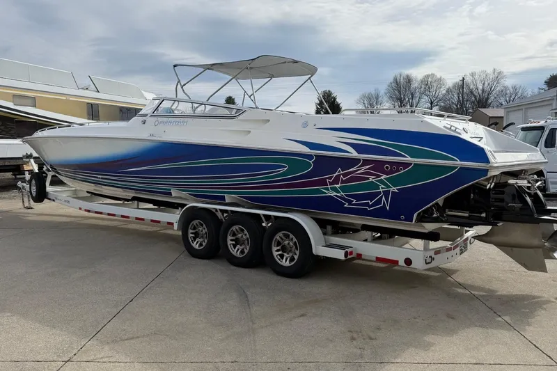  Yacht Photos Pics 2010 Fountain 42 Lightning speedboat with vibrant graphics on a trailer.