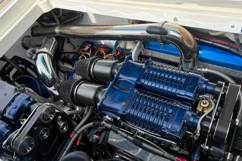  Yacht Photos Pics Engine of 2010 Fountain 42 Lightning boat with blue superchargers and chrome exhaust pipes.