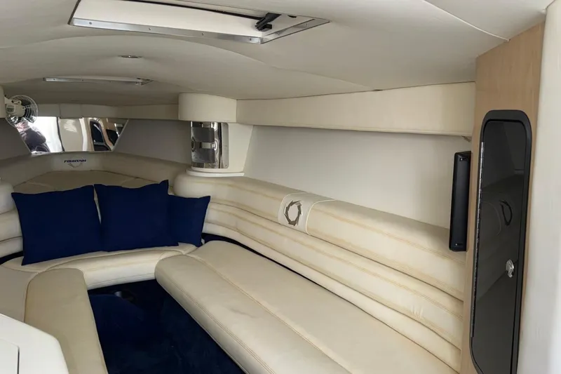  Yacht Photos Pics Interior of 2010 Fountain 42 Lightning boat with cream seating and blue cushions.