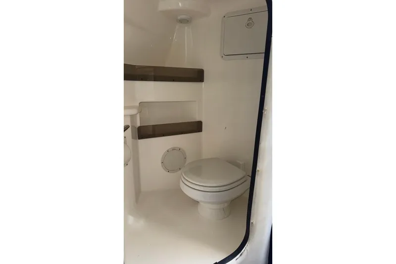  Yacht Photos Pics 2010 Fountain 42 Lightning boat interior bathroom with toilet and storage shelves.