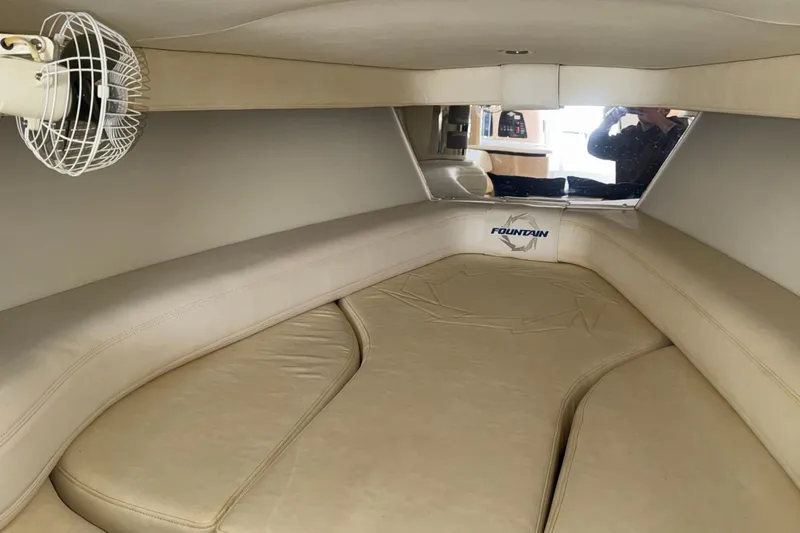  Yacht Photos Pics Interior cabin of 2010 Fountain 42 Lightning boat with beige seating and fan.