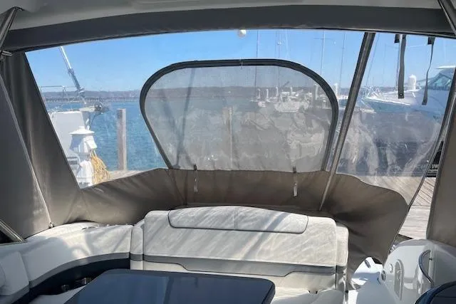  Yacht Photos Pics 2014 Formula 370 Super Sport boat interior with seating and clear canopy, docked by the water.