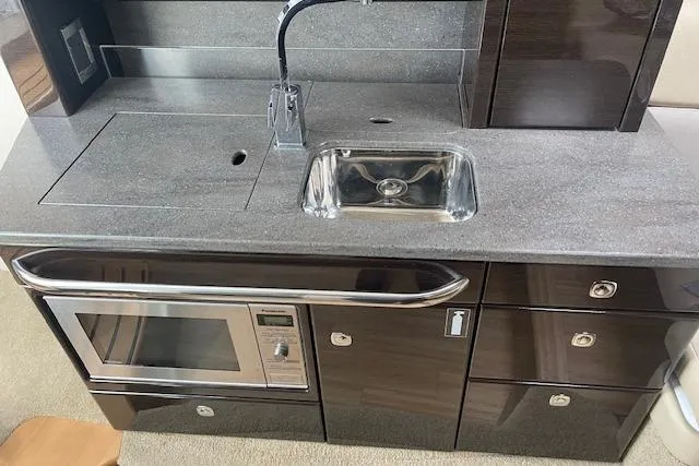  Yacht Photos Pics 2014 Formula 370 Super Sport yacht kitchenette with sink, microwave, and storage cabinets.