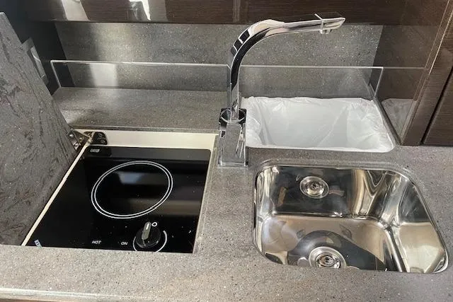  Yacht Photos Pics 2014 Formula 370 Super Sport kitchen with stove, sink, and modern faucet.