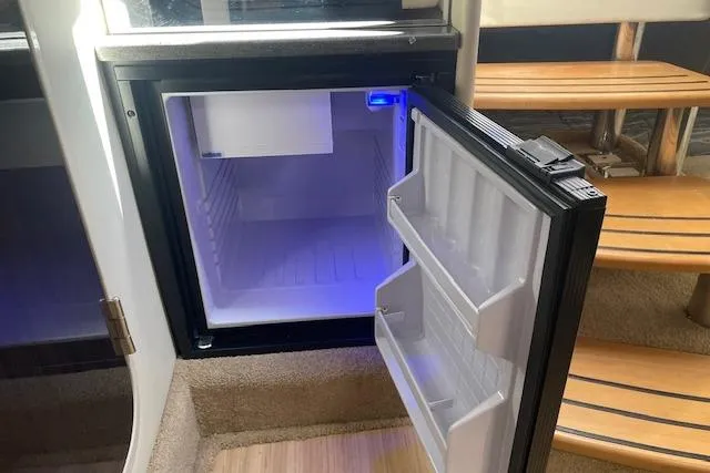  Yacht Photos Pics Open mini fridge inside 2014 Formula 370 Super Sport boat, with blue interior lighting.