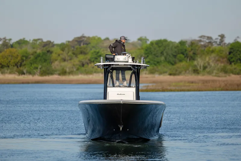  Yacht Photos Pics 2014 SeaHunter 32 Tournament boat navigating calm waters with lush greenery in the background.
