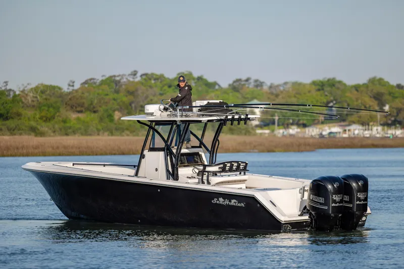  Yacht Photos Pics 2014 SeaHunter 32 Tournament boat with triple Yamaha engines on a calm waterway.