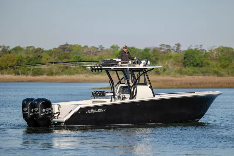  Yacht Photos Pics 2014 SeaHunter 32 Tournament boat on calm water with dual Yamaha engines.