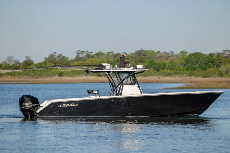  Yacht Photos Pics 2014 SeaHunter 32 Tournament boat on calm water with lush green shoreline.