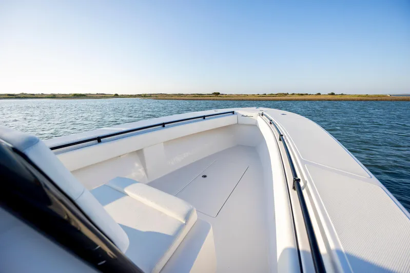  Yacht Photos Pics 2014 SeaHunter 32 Tournament boat on calm water, clear sky, scenic view.