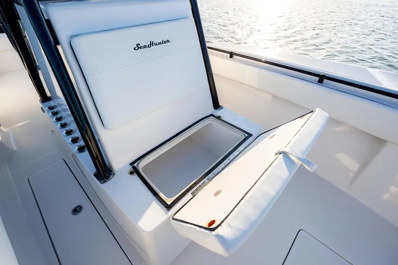  Yacht Photos Pics 2014 SeaHunter 32 Tournament boat with open storage compartment, white seating, and ocean backdrop.