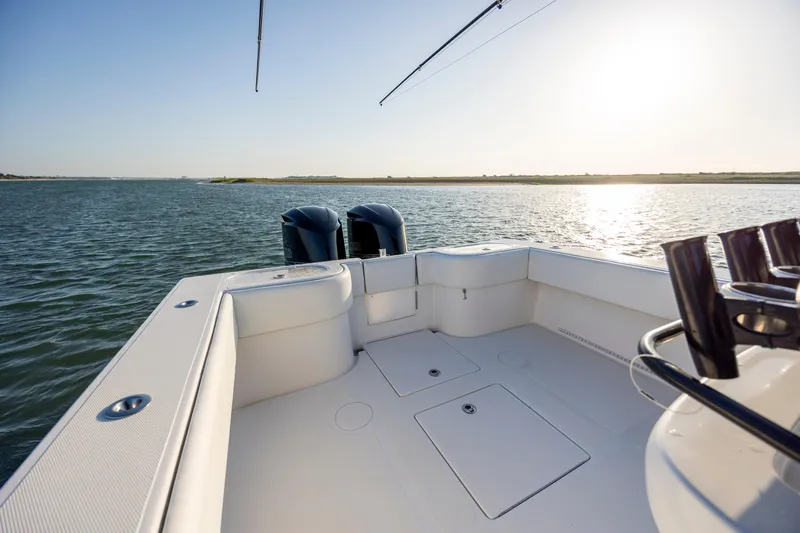  Yacht Photos Pics 2014 SeaHunter 32 Tournament boat deck with dual engines on calm water.
