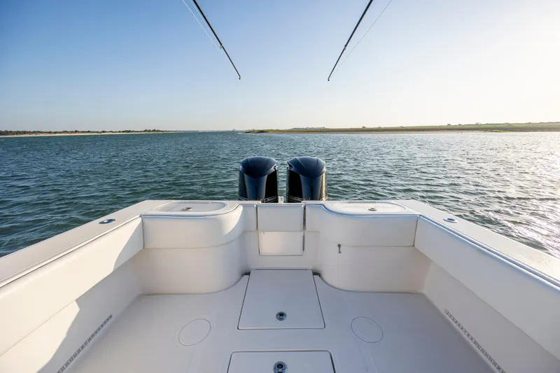  Yacht Photos Pics 2014 SeaHunter 32 Tournament boat on calm water, showcasing spacious deck and dual engines.