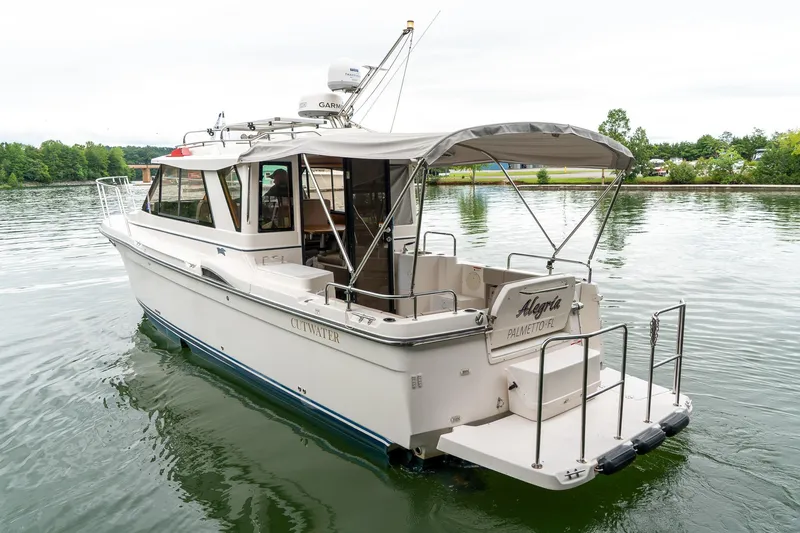  Yacht Photos Pics 2020 Cutwater C28 boat on calm water, featuring a spacious deck and canopy.