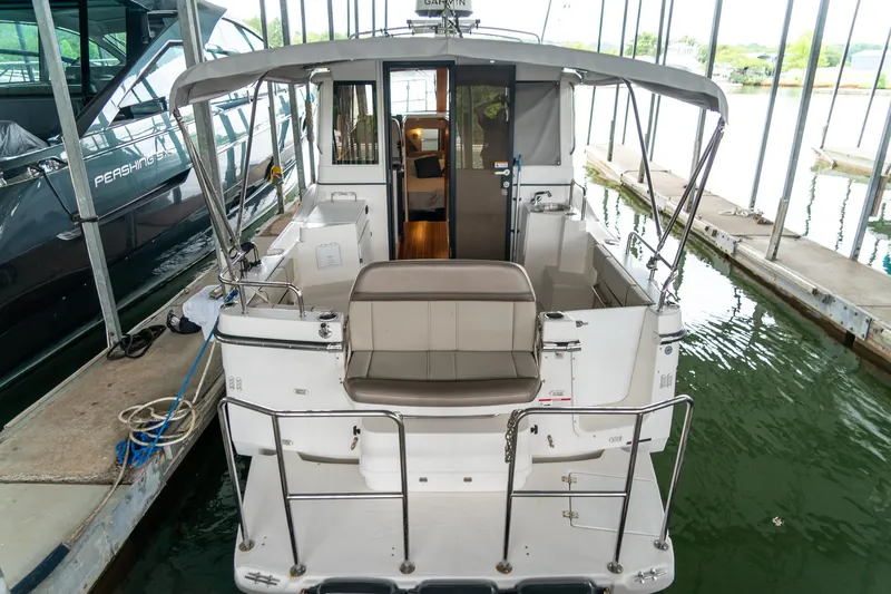  Yacht Photos Pics 2020 Cutwater C28 boat docked in marina, rear view showing seating and interior.