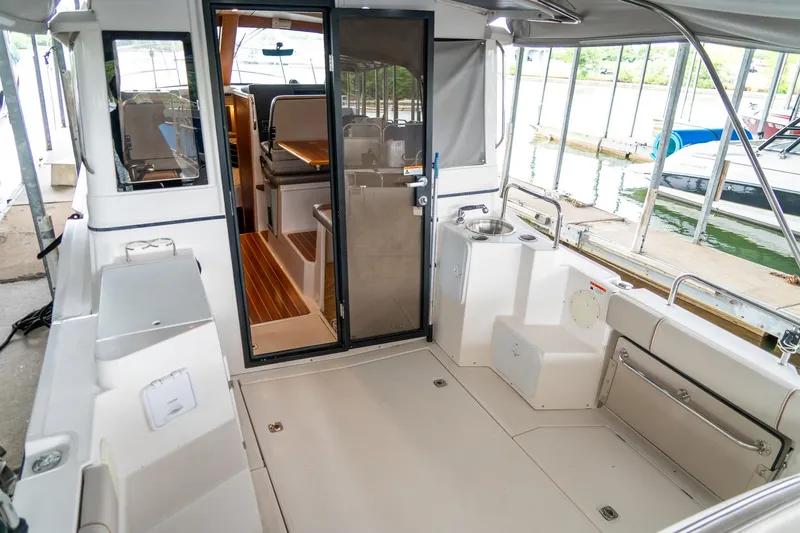  Yacht Photos Pics 2020 Cutwater C28 boat interior with open cabin door, docked at marina.
