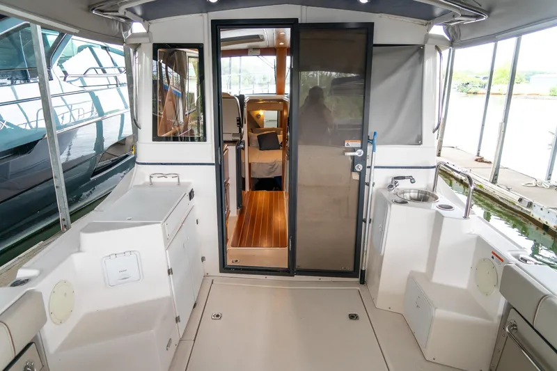  Yacht Photos Pics 2020 Cutwater C28 boat interior with open cabin door, showcasing sleek design and amenities.