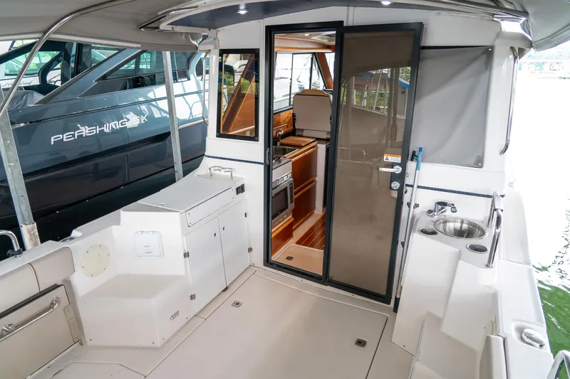  Yacht Photos Pics 2020 Cutwater C28 boat interior with kitchenette and seating area.
