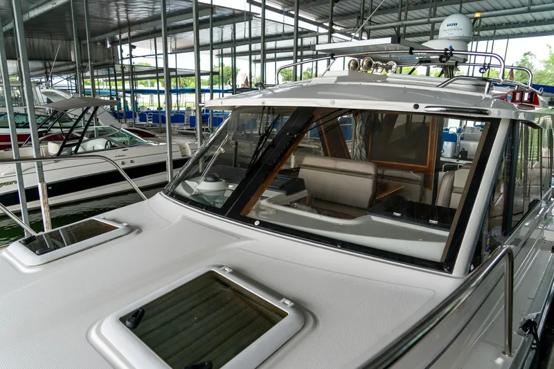  Yacht Photos Pics 2020 Cutwater C28 boat docked in a covered marina, showcasing sleek design.