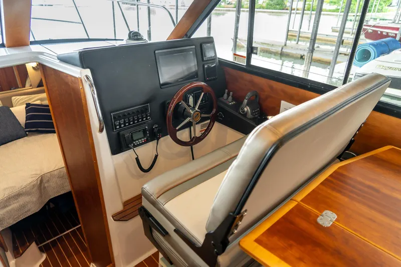  Yacht Photos Pics Interior helm of 2020 Cutwater C28 boat with steering wheel and navigation controls.