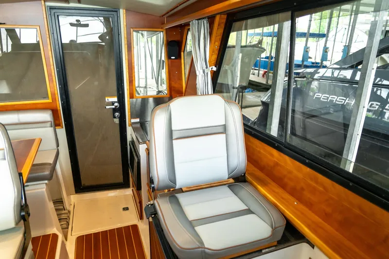  Yacht Photos Pics Interior of 2020 Cutwater C28 boat with seating and wooden accents.