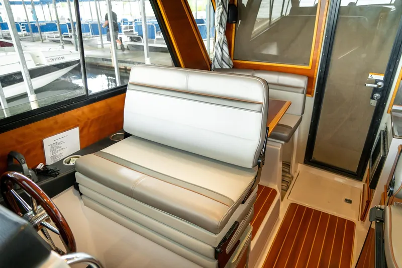  Yacht Photos Pics Interior of 2020 Cutwater C28 boat with seating and wooden accents.