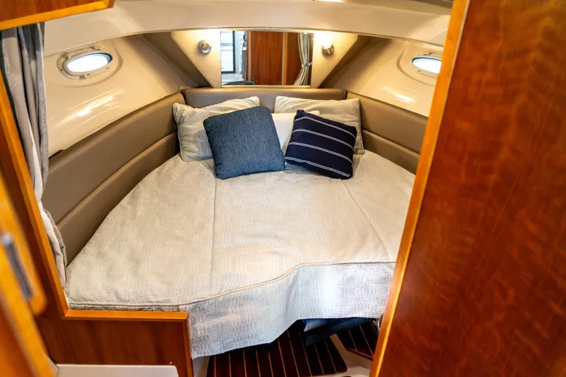  Yacht Photos Pics 2020 Cutwater C28 cabin interior with cozy bed and decorative pillows.