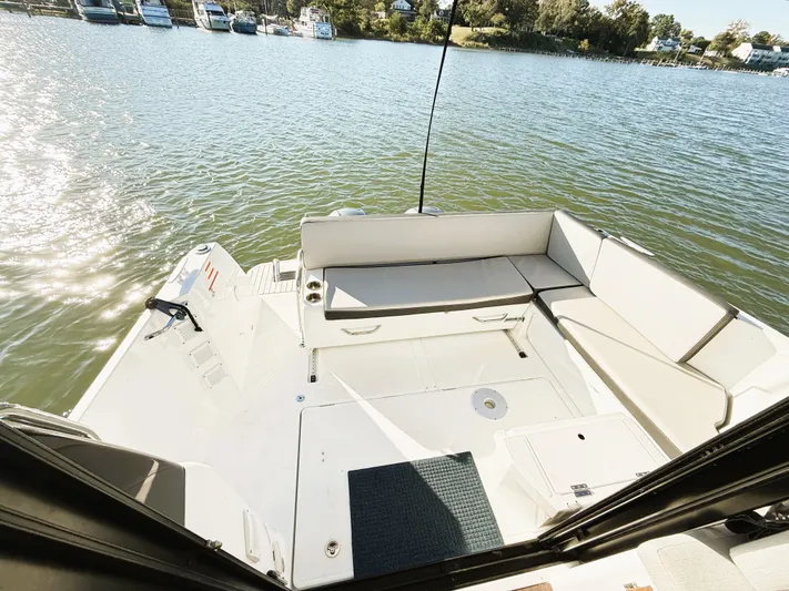  Yacht Photos Pics 2021 Jeanneau NC 895 boat deck with seating, overlooking a serene waterfront.