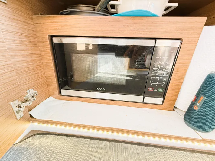  Yacht Photos Pics Microwave in 2021 Jeanneau NC 895 boat kitchen, wood paneling, modern design.
