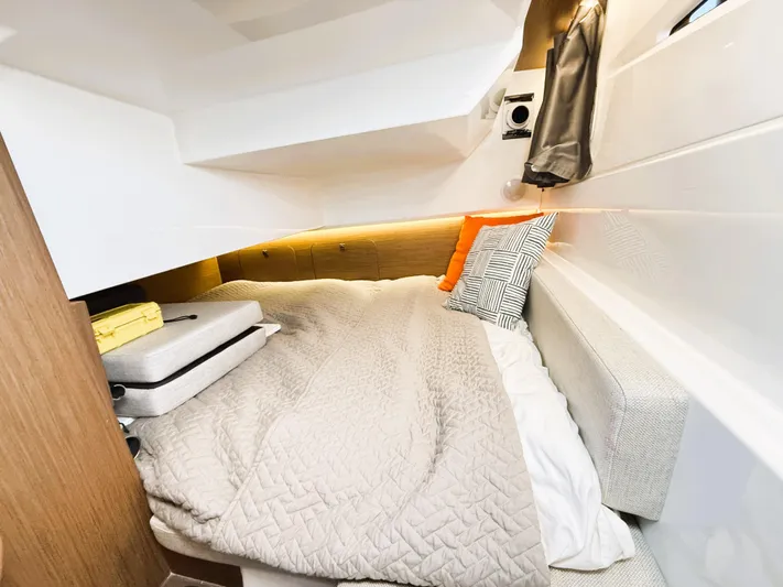  Yacht Photos Pics Cozy cabin interior of 2021 Jeanneau NC 895 with comfortable bedding and modern design.