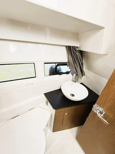 Yacht Photos Pics 2021 Jeanneau NC 895 bathroom with modern sink and window view.
