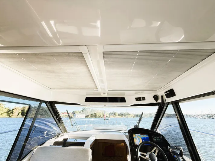  Yacht Photos Pics Interior view of 2021 Jeanneau NC 895 boat cockpit with panoramic windows.