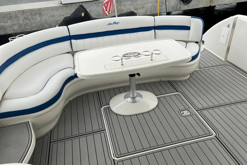 Mafe Yacht Photos Pics 2004 Sea Ray 500 Sundancer boat deck with curved seating and table.