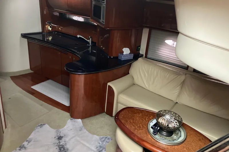 Mafe Yacht Photos Pics Luxurious interior of 2004 Sea Ray 500 Sundancer yacht with elegant kitchen and seating area.