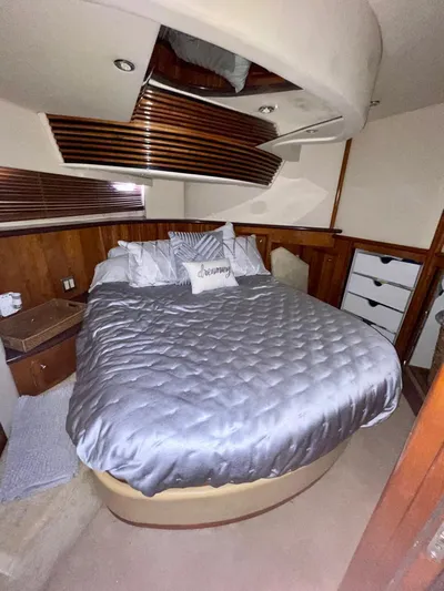  Yacht Photos Pics Luxurious bedroom in 2000 Carver 45 Voyager yacht with elegant bedding and wood accents.
