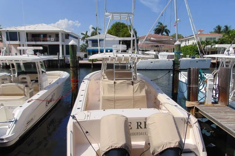 Fore Reel Yacht Photos Pics 2008 Grady-White Canyon 336 boat docked in a marina, surrounded by other vessels.