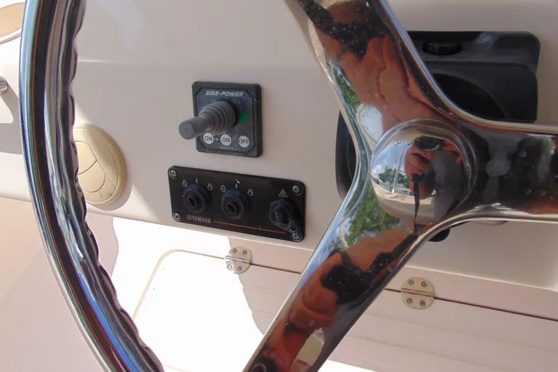 Fore Reel Yacht Photos Pics Steering wheel and controls of 2008 Grady-White Canyon 336 boat cockpit.