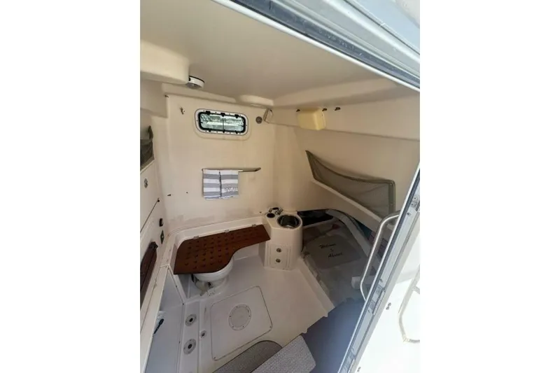 Fore Reel Yacht Photos Pics 2008 Grady-White Canyon 336 cabin interior with seating and storage.