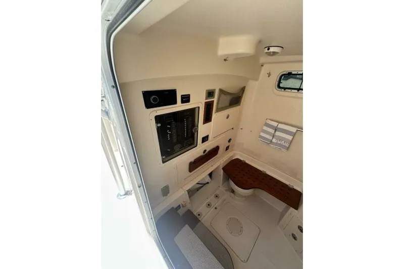 Fore Reel Yacht Photos Pics 2008 Grady-White Canyon 336 cabin interior with control panel and seating area.