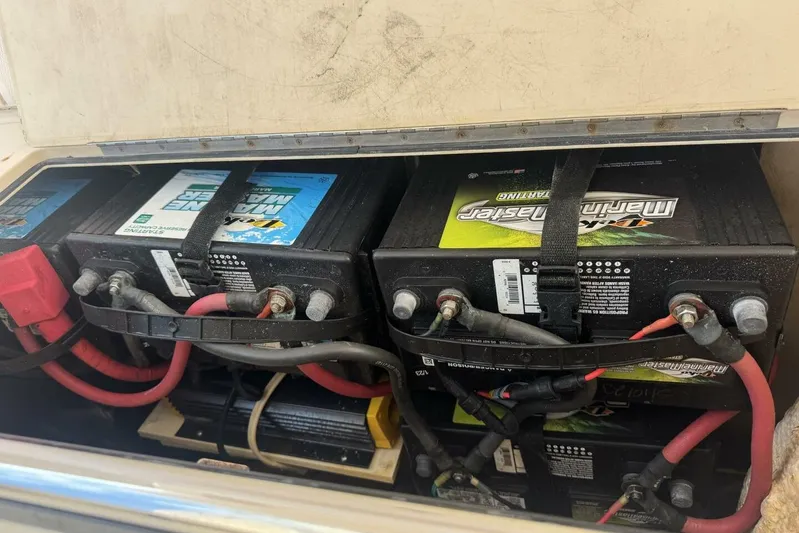 Fore Reel Yacht Photos Pics Marine batteries in a 2008 Grady-White Canyon 336 boat, secured with straps and connected with cables.