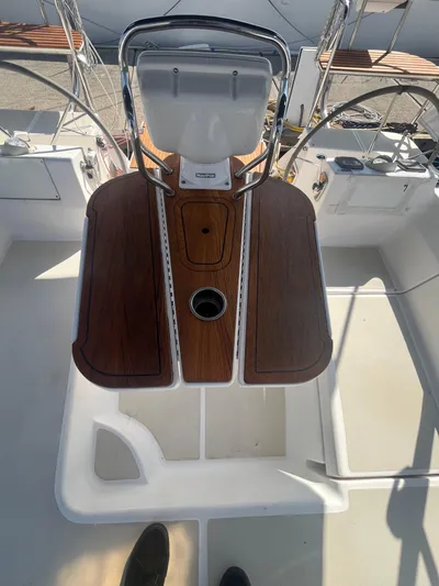 Pegasus Yacht Photos Pics Cockpit of 2015 Marlow-Hunter 40 sailboat with wooden table and steering wheel.
