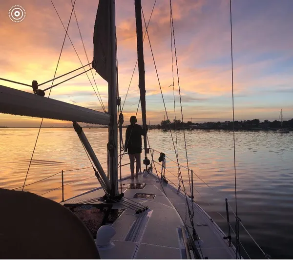 Pegasus Yacht Photos Pics Sailboat Marlow-Hunter 40 at sunset, 2015 model, with person on deck, calm waters.
