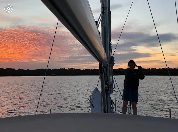 Pegasus Yacht Photos Pics Sailboat at sunset, Marlow-Hunter 40, 2015 model, person on deck, vibrant sky.