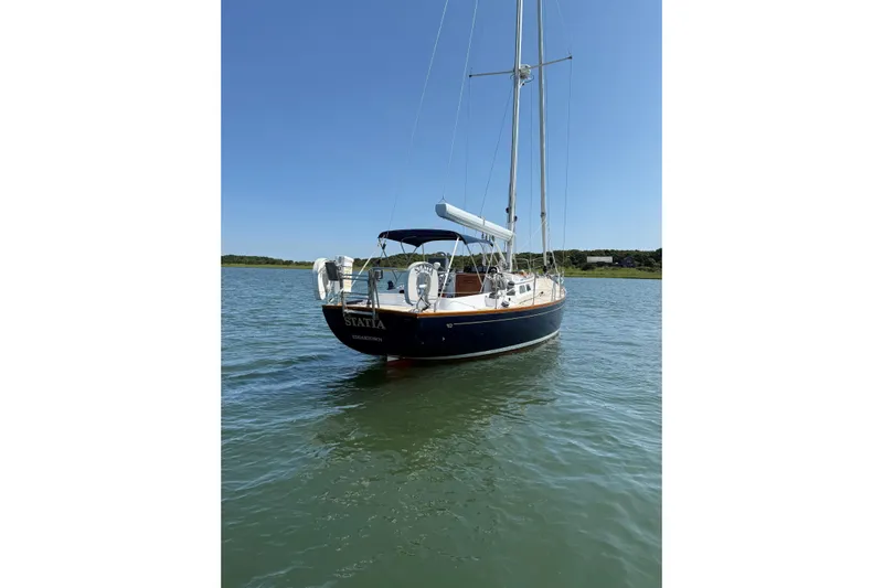 Statia Yacht Photos Pics Hinckley Sou'wester 42 Sloop, 1994, anchored in calm waters under clear blue sky.