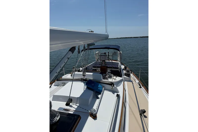 Statia Yacht Photos Pics Hinckley Sou'wester 42 Sloop, 1994, sailing on calm waters under clear skies.