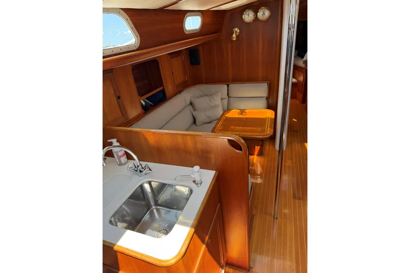 Statia Yacht Photos Pics Interior of 1994 Hinckley Sou'wester 42 Sloop with wooden finish and cozy seating area.